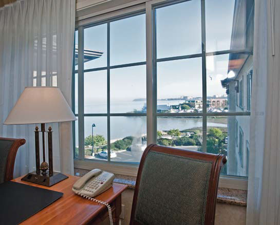 This picture shows a desk in front of a window looking out over the bay.