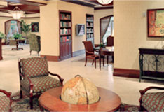 This is a picture of the lobby near the elevators. It shows a sitting area with 4 chairs and a center table and world globe.